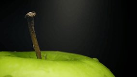 Slow motion water splash on fresh green apple macro, high speed droplets, clean dark background - Powered by Shutterstock - Get 15% off with code: PIKWIZARD15