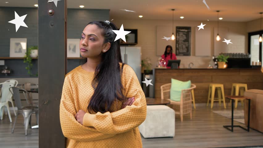 Woman leaning arms crossed in lobby, stars entering and drifting around woman, enhancing cafe mood. Lounge, contemporary, earthy, knit, texture, guest, staff