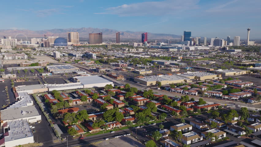 Aerial Rising Shot of Las Vegas suburbs with Strip skyline and desert mountains
