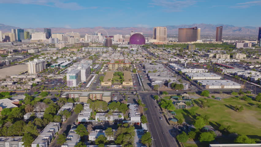 Aerial view of Las Vegas suburbs and Strip skyline and desert mountains