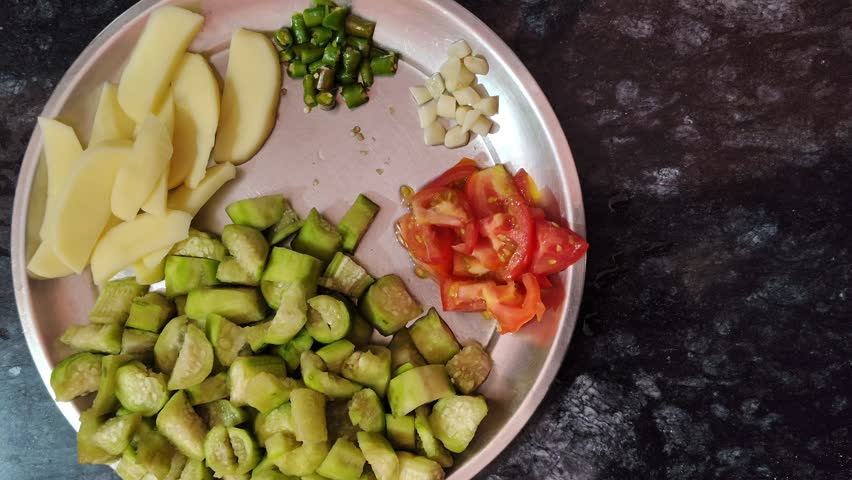 Fresh Ingredients Ready for Cooking Chopped Turai, Potato, and Tomato Platter