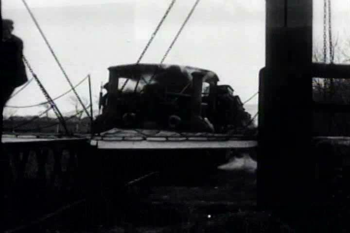 1910s, 1920s - A bridge opens so a train can pass through.
