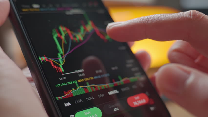 Person analyzing market chart on smartphone trading app. Concept of stock market analysis, online investment, portfolio management and mobile finance.