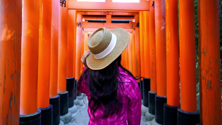 Tourists visiting at fushimi inari shrine in Kyoto, Japan.