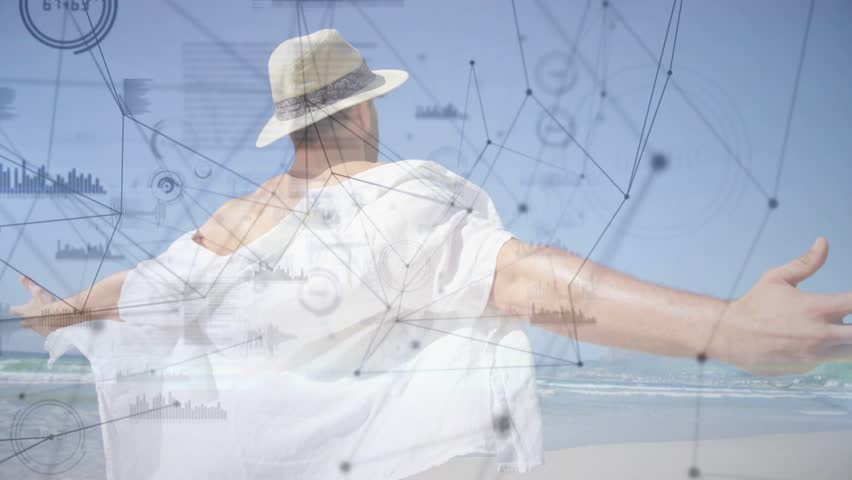 Breeze nudging shirt, man in hat rotating, sweeping arms, showing tech, HUD overlaying scene. Beach, coastal, motion, network, data, silhouette, sunlit