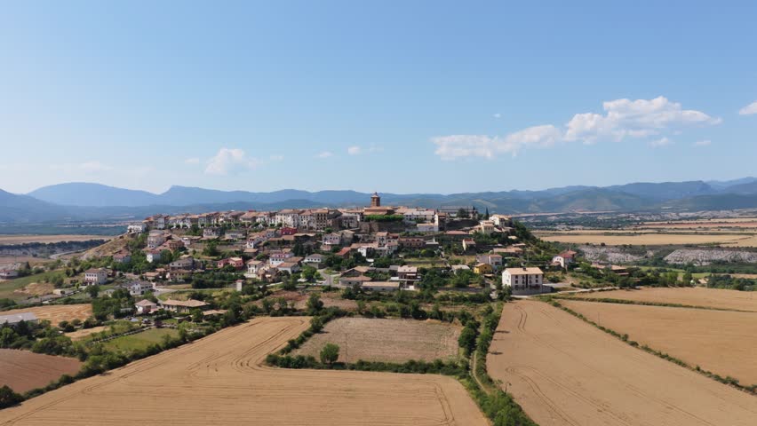 Aerial view of the medieval village of Berdun in Huesca, Spain. Beautiful cityscape on top of a hill surrounded by golden wheat fields