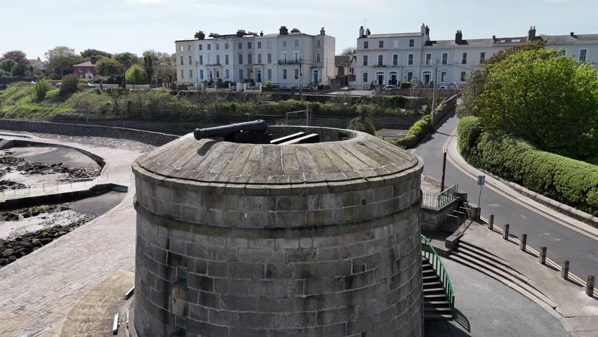 A smooth circular tracking shot around the historic Martello Tower at Seapoint in Dublin, captured on a bright sunny day. The video highlights the tower’s distinctive round stone structure, coastal setting, and clear daylight conditions, conveying a sense of history and openness by the sea. Ideal for themes related to Irish heritage, coastal landmarks, tourism, and scenic outdoor locations.