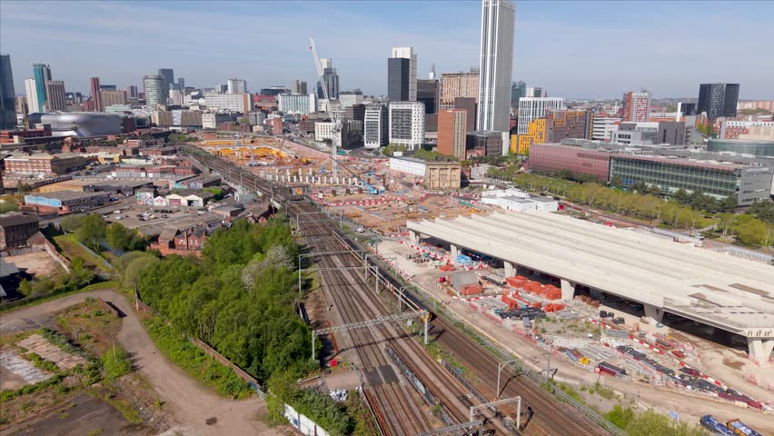 Aerial panoramic footage above the new HS2 construction site in the centre of a Birmingham cityscape skyline with engineering equipment. New Birmingham to London HS2 rail link in Birmingham Curzon Street area.