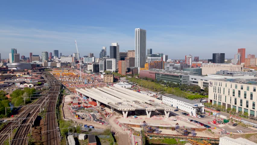 Aerial panoramic footage above the new HS2 construction site in the centre of a Birmingham cityscape skyline with engineering equipment. New Birmingham to London HS2 rail link in Birmingham Curzon Street area.