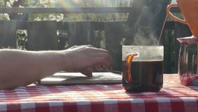 Close up of hands typing on laptop with cup of coffee on rustic terrace table in sunlight. Remote work concept and outdoor productivity in nature. Cozy countryside lifestyle series — outdoor cooking, coffee ritual and remote work on terrace with mountain view. - Powered by Shutterstock - Get 15% off with code: PIKWIZARD15