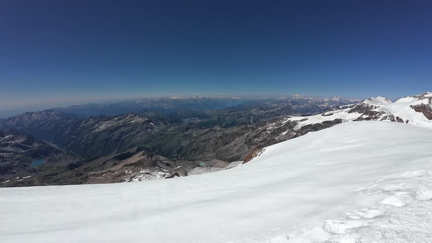 Pan shot of mountain glacier panorama with summits Gran Paradiso, Mont Blanc massif, Lyskamm, Weisshorn, Corno Nero (Schwarzhorn) and Parrotspitze in Pennine Alps, Italy