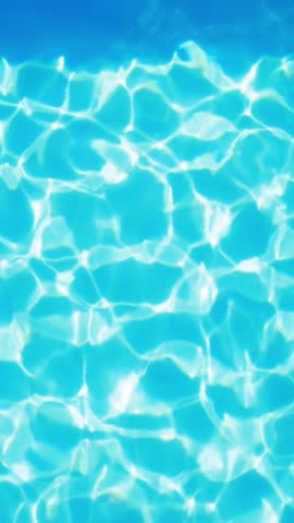 Overhead of swimming pool glimmering on a sunny day