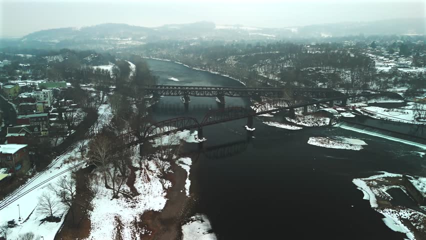 Aerial view of multiple bridges over winter river in Easton