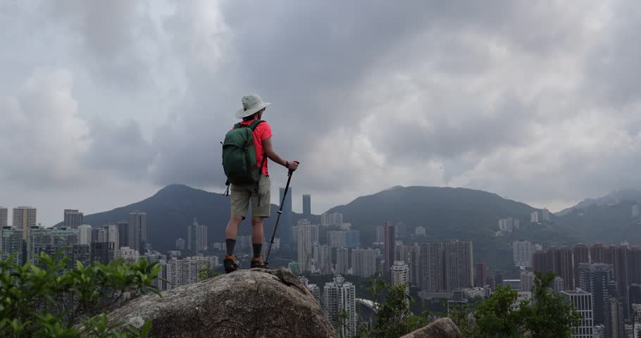 Woman hiking on mountain top in Hong Kong	