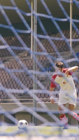 Football player scoring a goal on the football ground