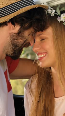 Hipster couple embracing at a music festival
