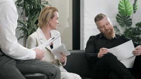 Business team discussing documents during meeting decision making and collaboration in modern office environment. - Powered by Shutterstock - Get 15% off with code: PIKWIZARD15