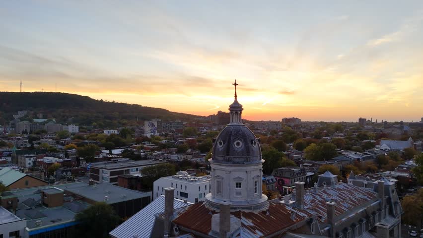 Aerial view of Montreal skyline with domed church tower against cityscape. g.