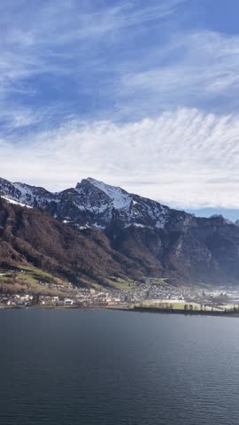 Vertical aerial view of Churfirsten mountains and Walensee lake near Walenstadt Switzerland scenic landscape.