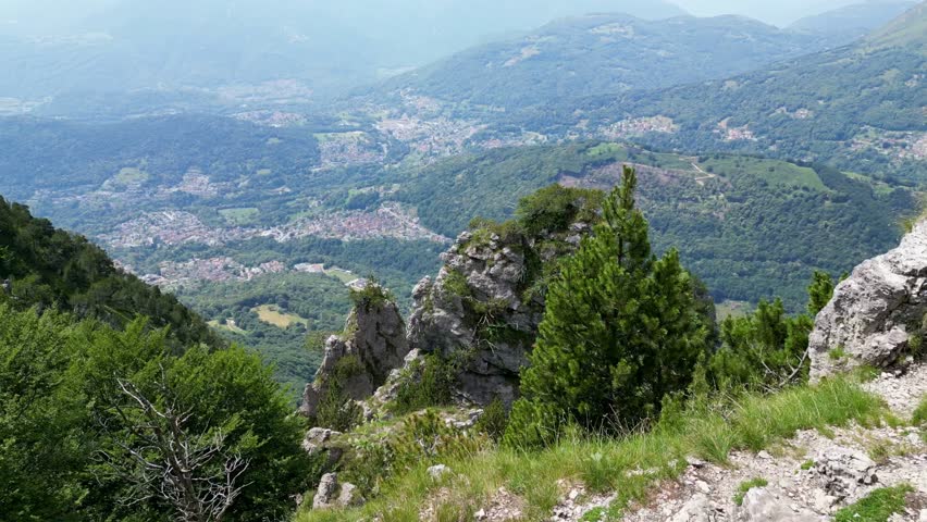 Wide breathtaking shot of a mountain landscape with a small village below.