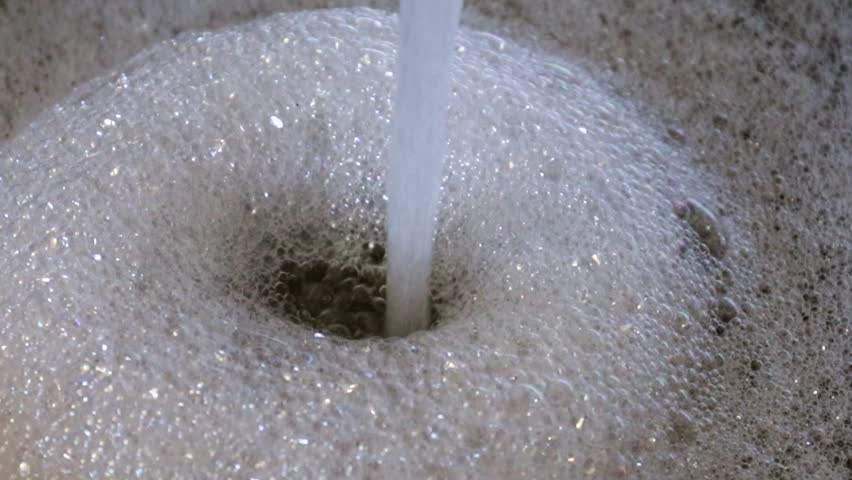 a stream of clean water and suds in the sink