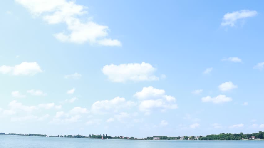 Sunny Summer Sky with White Clouds over Lake Palic Shoreline