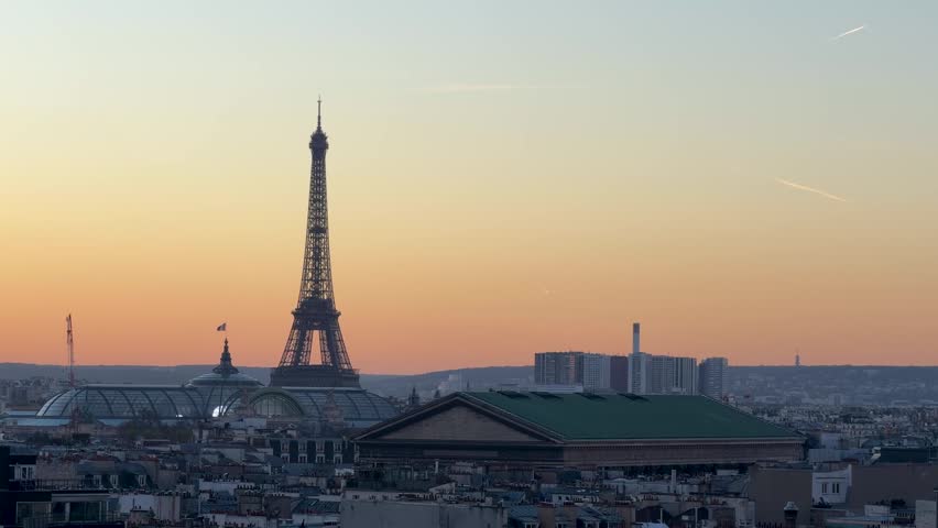Dawn over Paris. Gentle morning illuminates historic Paris rooftops