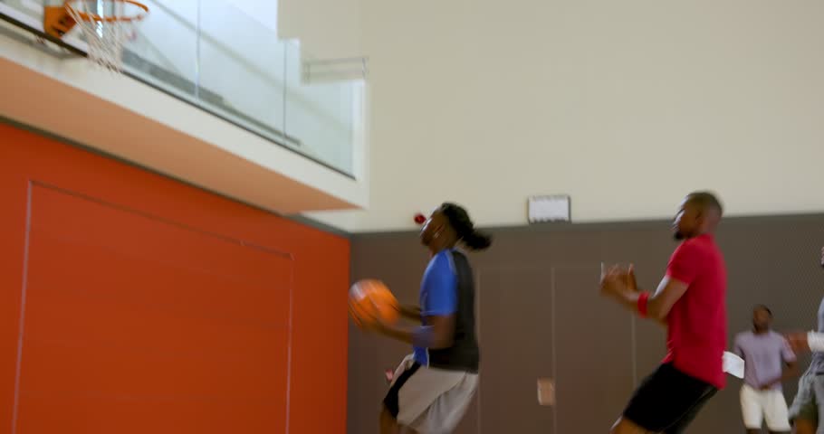 Playing pickup basketball, diverse male friends dribbling on gym court with orange basketball. Athletic, teamwork, sport, vibrant, leisure, competitive, active