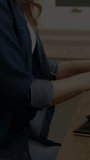 Vertical video: Woman coding at desk, causing code overlay scrolling and filling frame for project. Programmer, laptop, typing, office, workspace, concentration, vertical video - Powered by Shutterstock - Get 15% off with code: PIKWIZARD15