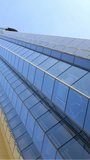 Vertical video: Facade showing wordcloud at start, animating while camera tilting showing values. Skyscraper, glass, reflection, cityscape, modern, bluesky, vertical video - Powered by Shutterstock - Get 15% off with code: PIKWIZARD15