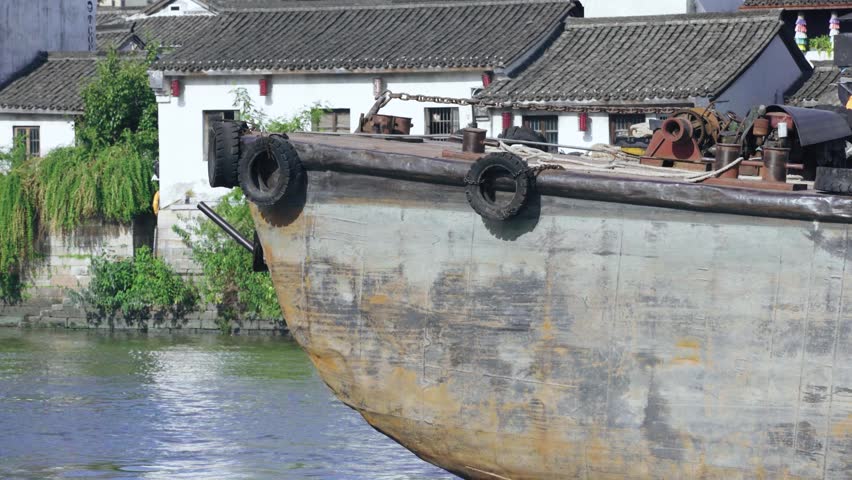 Gongchen Bridge on the Grand Canal in Hangzhou, a UNESCO World Heritage site with cargo ships passing by.