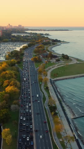 Lakefront highway and cityscape at sunset. Aerial view of a busy highway along Chicago