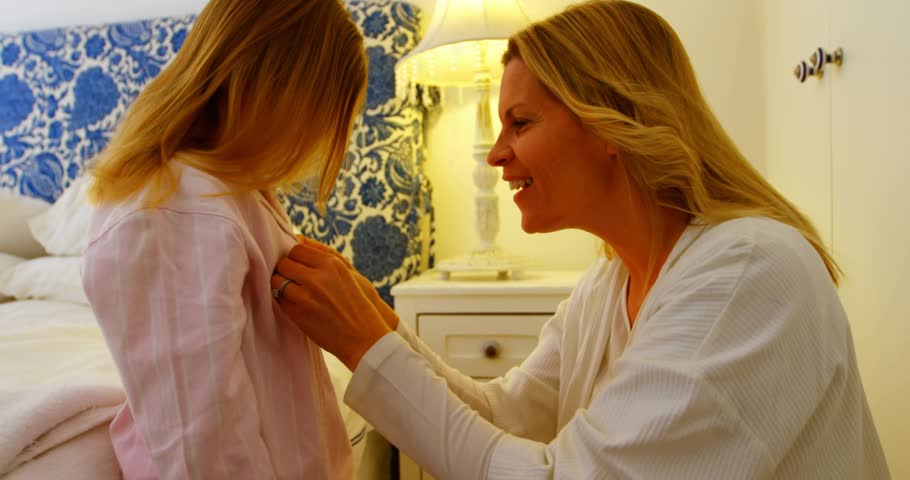 Family mom fastening child