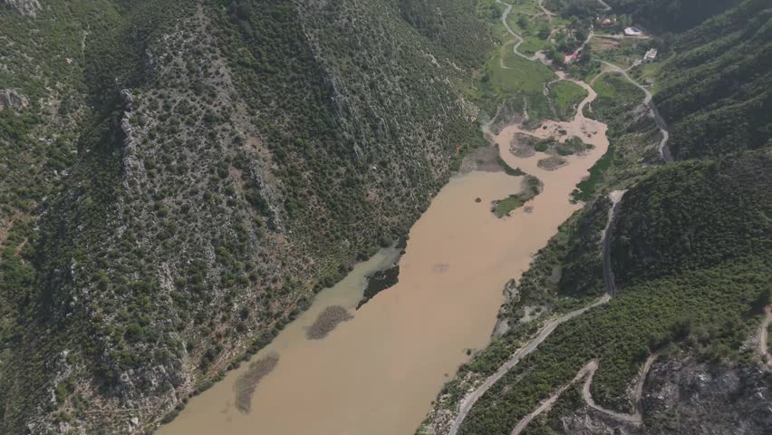 Drone shot capturing the dam of Oyoun El Samak in Akkar with wide water view and scenic mountain background