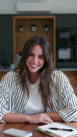 Happy young woman with a radiant smile and positive energy, looking thoughtfully around her home, portraying joy and contentment.