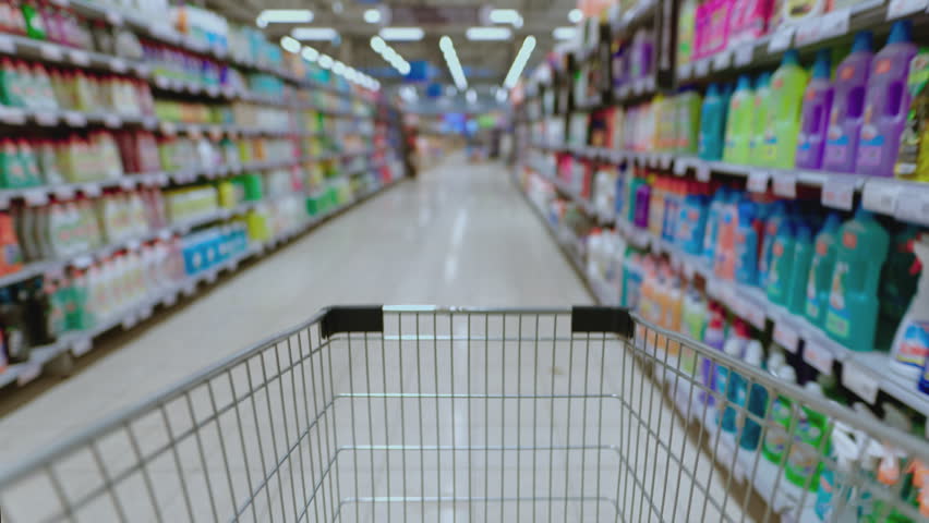 Walk through supermarket with an empty shopping cart. Customer makes purchases, spends money. Black Friday or discount season. Timelapse. Grocery store and sections with goods.