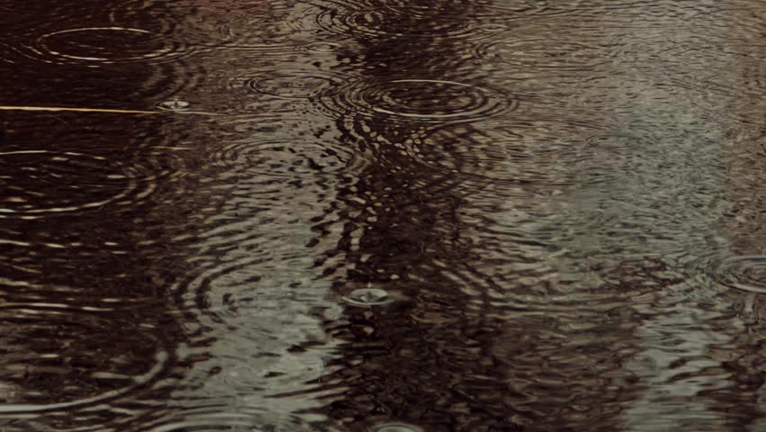 Raindrops Falling Into Dark Water Surface Creating Concentric Ripples, Abstract Nature Background With Rainy Day Texture, Calm Water Motion, Fluid Dynamics Close Up, Wet Weather Atmosphere, Peaceful Water Surface, Droplet Impact, Water Waves, 