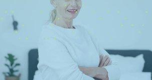 Senior woman posing by bed smiling green overlay fading over face camera zooming promoting health. Bedroom, calm, serene, confident, mature, plant, minimal - Powered by Shutterstock - Get 15% off with code: PIKWIZARD15