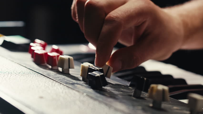 Playing piano vintage retro synthesizer. Close up of man hands playing jazz on the piano. Fingers on the piano, vintage colors. A very close look at a jazz pianist hands. Man playing the piano, close