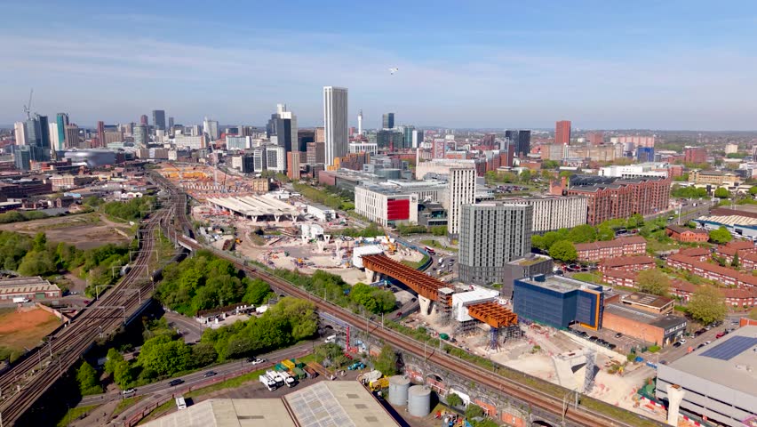 An aerial panoramic view of Birmingham cityscape skyline with the HS2 construction site and railway tracks running alongside University buildings on Curzon Street