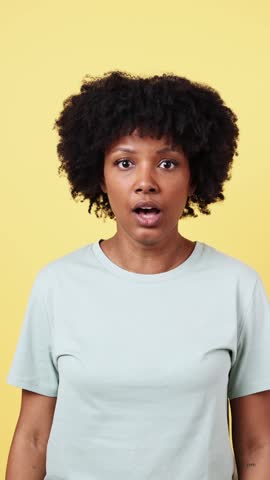Young african american woman showing different expressions on yellow background