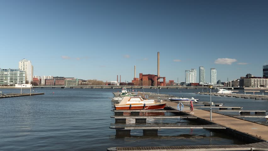 Harbor with parked boats and yachts near city skyline calm water marina scene urban waterfront atmosphere travel destination coastal lifestyle peaceful composition