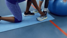 Therapist kneeling, reaching, adjusting prosthetic shoe and pylon for rehab while UI tags appearing. Prosthesis, rehabilitation, therapy, alignment, balance, mobility, clinic - Powered by Shutterstock - Get 15% off with code: PIKWIZARD15