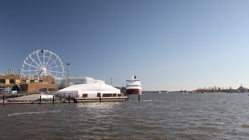 Wide waterfront view in helsinki with ferris wheel in distance scenic coastal city landscape and travel atmosphere