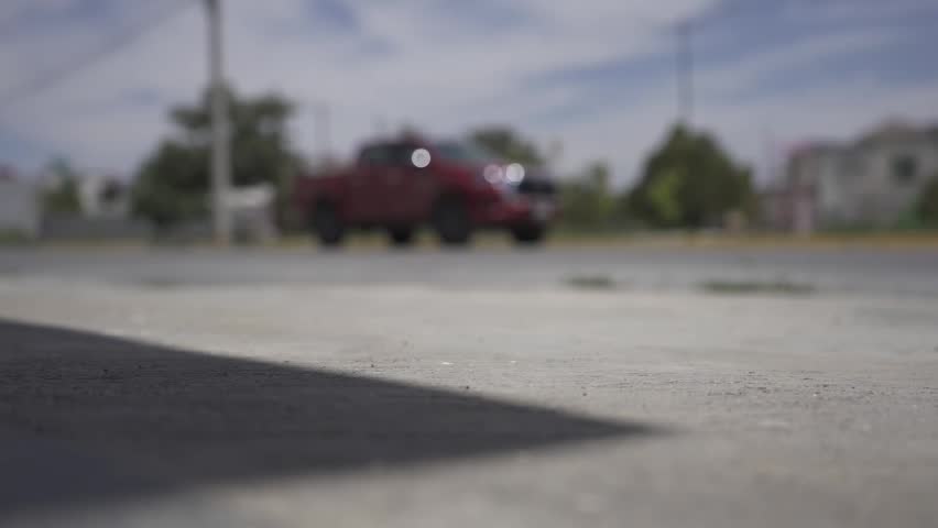 A shot of a remote control car parking in front of a house in a neighborhood