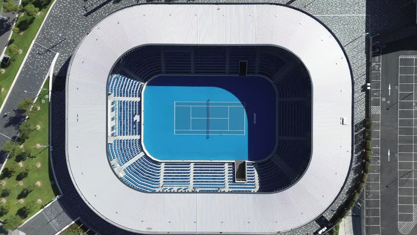 Melbourne, Victoria, Australia – April 17, 2026: Aerial top-down view of tennis stadium with empty court and seating in sports precinct