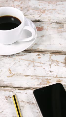 Cup of tea, laptop, smartphone, diary and pencil on wooden surface