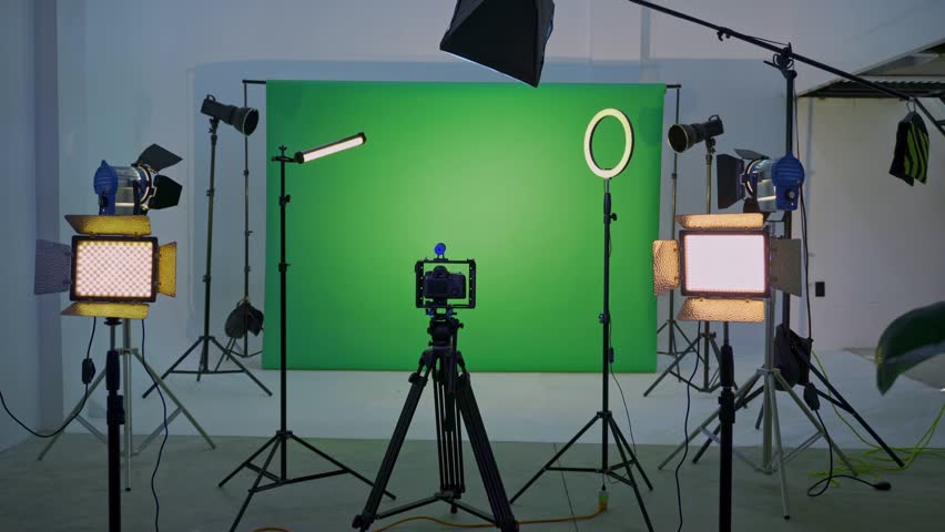 Empty film production studio with chroma key background and professional lighting equipment