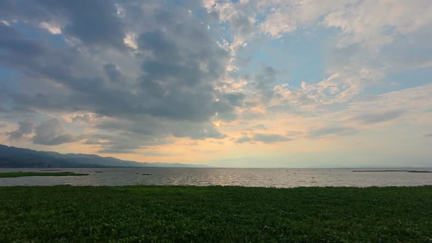 Timelapse of Sunset Over Calm Lake with Greenery