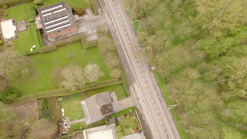 Above View Of A Countryside Road Through Town In Spring. Aerial Topdown Shot